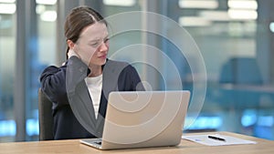 Young Businesswoman having Neck Pain while Typing on Laptop