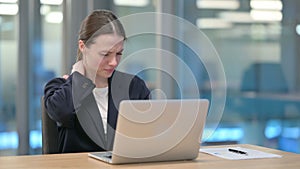 Young Businesswoman having Neck Pain while using Laptop