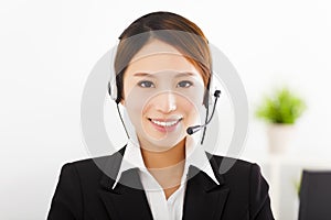 Young businesswoman with headset in office
