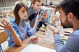 Young businesswoman helplessly spreading hands, explaining, defending herself about bad business after corona virus photo