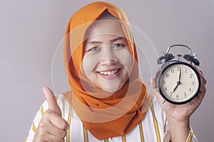 Young Businesswoman Holding a Clock