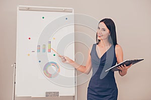 Young businesswoman holding folder and making presentation about financial growth of company photo