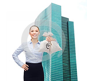 Young businesswoman holding money bags with euro