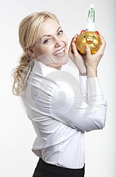 Young businesswoman holding a piggybank