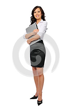 Young businesswoman with laptop standing