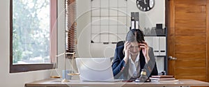 A young businesswoman lawyer is looking stressed as she works at her computer. consultant lawyer, justice and law