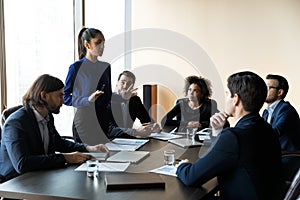 Young businesswoman lead office meeting with diverse colleagues
