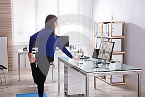 Young Businesswoman Doing Yoga