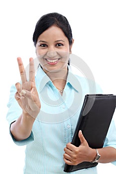 Young businesswoman making victory gesture