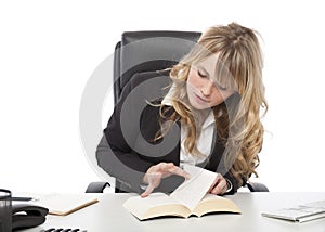 Young businesswoman paging through a book