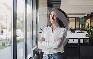 Young businesswoman portrait, Self confident young woman with crossed arms at office, People candid portraits