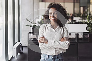 Young businesswoman portrait, Self confident young woman with crossed arms standing at office