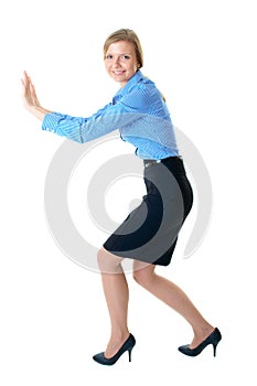 Young businesswoman push imaginary wall, isolated