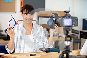 young businesswoman recording vlog talking to camera