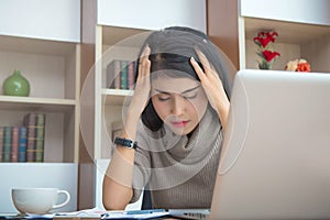 Young businesswoman or secretary tired and Stressed from work with laptop computer at office