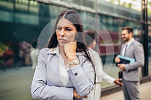 Businesswoman with serious expresison standing at the city