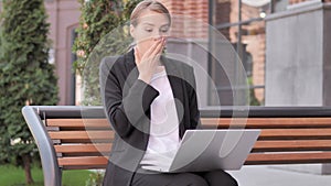 Young Businesswoman in Shock while Working on Laptop Outdoor