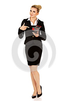 Young businesswoman with shopping trolley