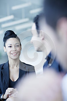 Young businesswoman sitting in a business meeting with colleagues