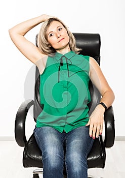 Young businesswoman sitting on chair doing fitness exercise at workplace