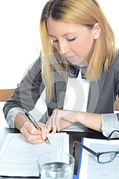 Young businesswoman sitting at desk with laptop