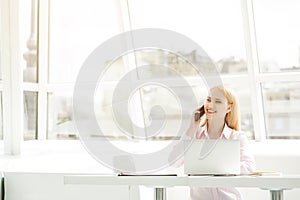 Young businesswoman sitting at office