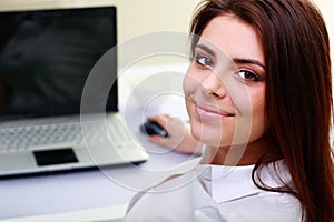 Young businesswoman sitting at the table