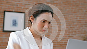 Young businesswoman sitting on the workspace desk using laptop. Vivancy