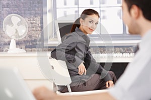 Young businesswoman smiling at her colleague