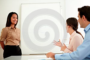 Young businesswoman smiling at professional team