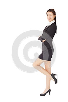 Young businesswoman standing and across arms