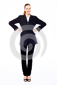 Young businesswoman standing with arms akimbo