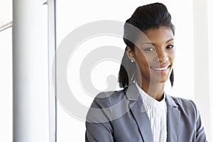 Young Businesswoman Standing In Corridor Of Modern Office Building