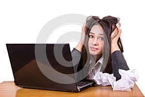 Young businesswoman in stress at laptop