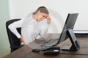 Businesswoman Suffering From Backache And Headache