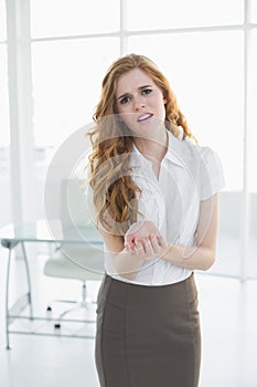 Young businesswoman suffering from wrist pain in office