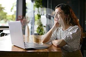 Young Businesswoman With Takeaway Coffee Working Sitting On Laptop In Coffee Shop Or Office
