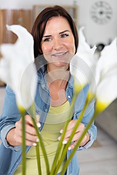 young businesswoman takes care plants at home