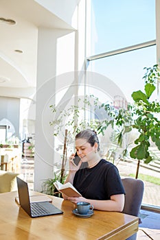 Young Businesswoman Taking Call in Sunlit Workspace