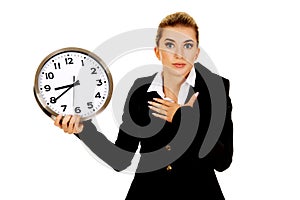 Young businesswoman terrified looks at the clock