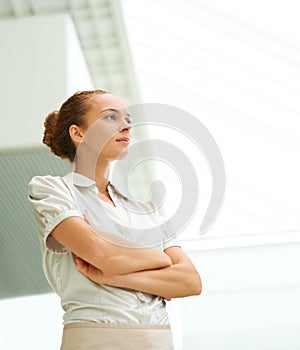 Young businesswoman thinking for the future perspective. Thoughtful young woman with her hands folded looking away at