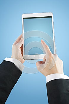 Young businesswoman touching screen on digital tablet computer