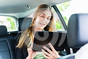 Young businesswoman traveling in taxi