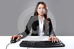 Young businesswoman typing on keyboard