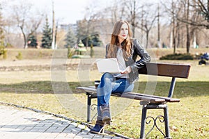 Young businesswoman use laptop sitting in the park