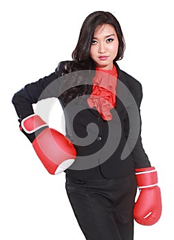 Young businesswoman using boxing gloves