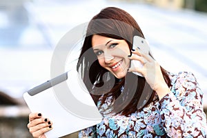 Young businesswoman using digital tablet and mobile phone photo