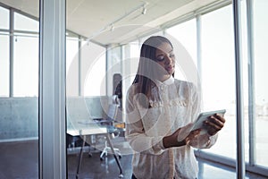 Young businesswoman using digital tablet in office