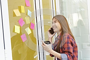 Young businesswoman using mobile in office. Modern wireless connection technology for work