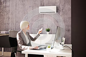 Young Businesswoman Using Air Conditioner
